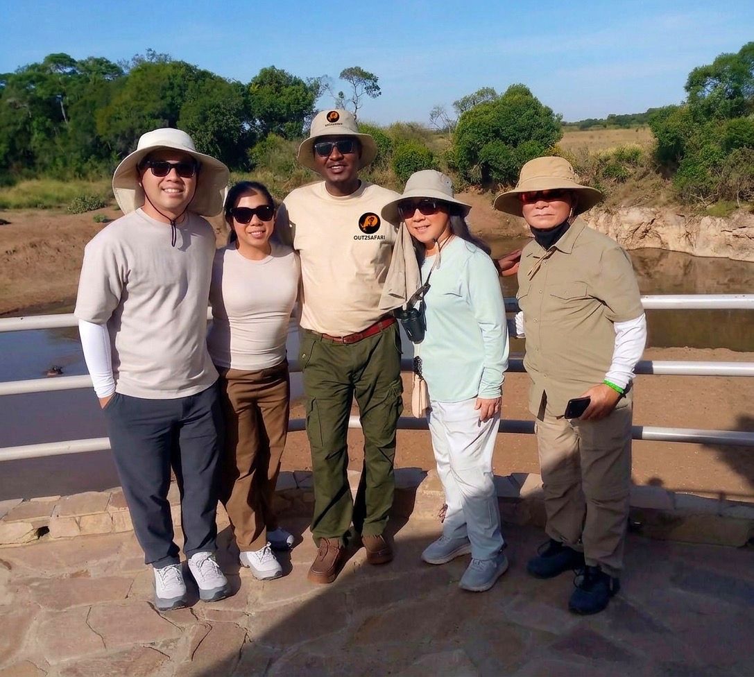 An Out2safari lead guide with guests in the field